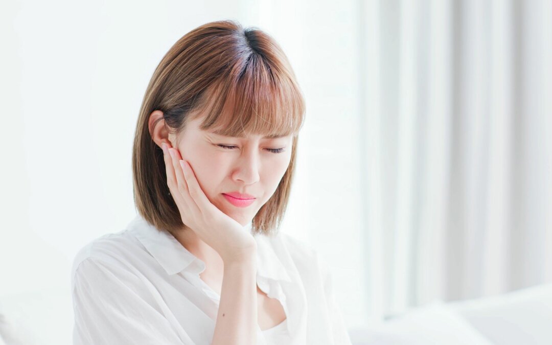 woman feeling pain due to gum disease