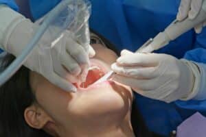woman undergoing a dental scaling procedure